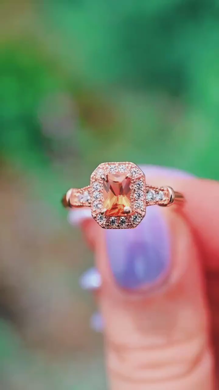 Video of the Vintage Halo Padparadscha Sapphire Ring in 14K Rose Gold Vermeil by Aquamarise, showing the orange sapphire in motion