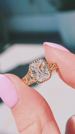 Product video of the Lab Grown Diamond Engagement Ring in Solid 14K Yellow Gold by Aquamarise, showing the radiant-cut lab-grown diamond in a vintage-inspired yellow gold setting.