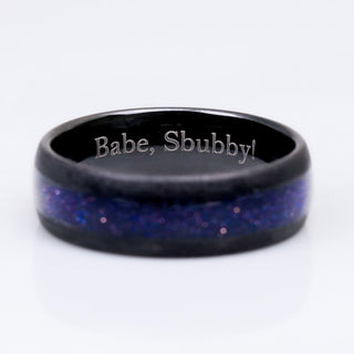 Black ring with blue glittery interior and 'Babe, Sbubby!' engraving on a white background