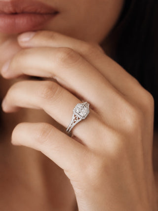 Woman wearing a sterling silver marquise diamond halo engagement ring with a pave band, hand raised to her face, Aquamarise lifestyle banner
