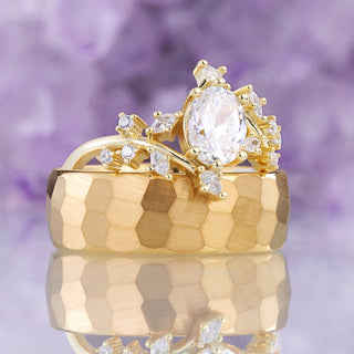 Simulated Diamond Leaf couples ring set, oval leaf and twig ring in yellow gold resting on the hammered gold tungsten men's band