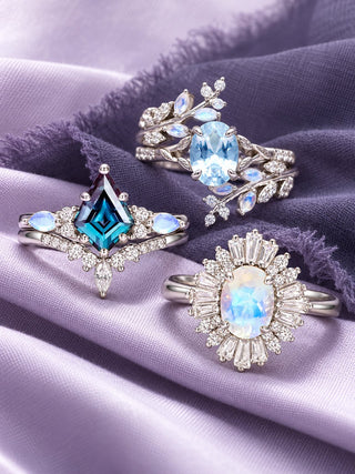 Gemstone engagement rings on lavender and nightshade silk: Skye Kite alexandrite and moonstone ring set, aquamarine and moonstone fairy leaf ring set and Victoria Art Deco moonstone ring, Aquamarise banner