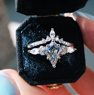 Diamond ring in a black velvet box held by a hand