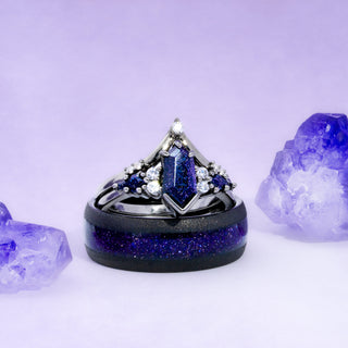 Elegant ring with blue gemstone and black band on a light purple background
