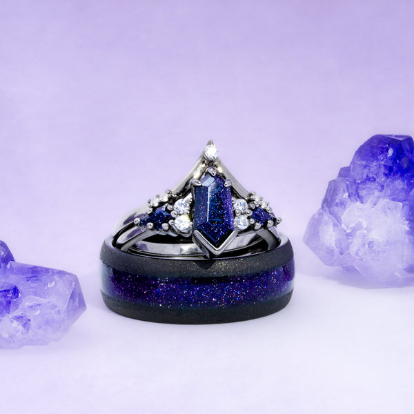 Elegant ring with blue gemstone and black band on a light purple background