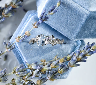 Toi Et Moi Simulated Aquamarine Leaf Vine Engagement Ring in Sterling Silver in a blue velvet ring box with lavender