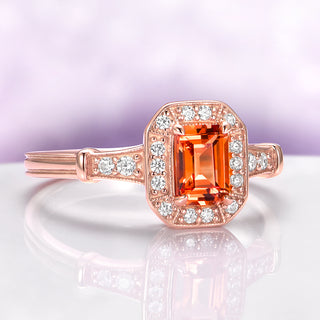 Vintage Halo Padparadscha Sapphire Ring in 14K Rose Gold Vermeil by Aquamarise, showcasing an emerald-cut orange sapphire surrounded by sparkling halo and diamond accents.