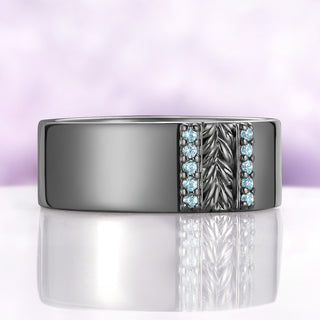 Angled view of the Viridian Leaf & Aquamarine men's wedding band in black ruthenium showing the leaf relief and five aquamarines per channel