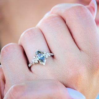 Viridian marquise green tourmaline engagement ring in sterling silver worn on a model's hand