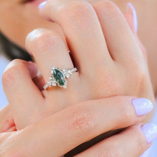 Viridian marquise moss agate engagement ring in sterling silver worn on a model's hand