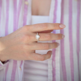 Heart White Sapphire Promise Ring in Sterling Silver by Aquamarise, showcasing a heart-shaped white sapphire with pavé accents on a polished sterling silver band, worn on a hand.