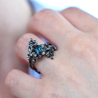 Wisteria alexandrite fairy leaf two-piece ring in black ruthenium worn on a model's hand