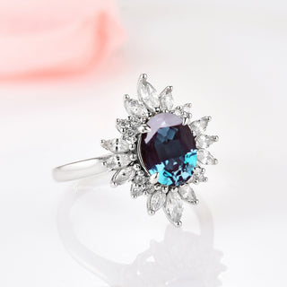 Aurora Alexandrite Ring - Sterling Silver by Aquamarise featuring an oval alexandrite center with a halo of marquise and round simulated diamonds on a rhodium-finished sterling silver band.
