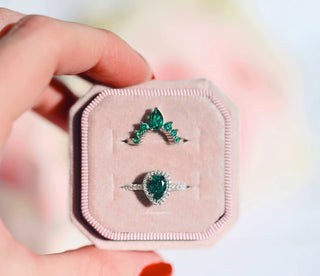 Amy Vintage Emerald Ring Set in Sterling Silver by Aquamarise featuring pear-shaped emeralds with diamond accents in a vintage-inspired design displayed in a soft pink velvet box