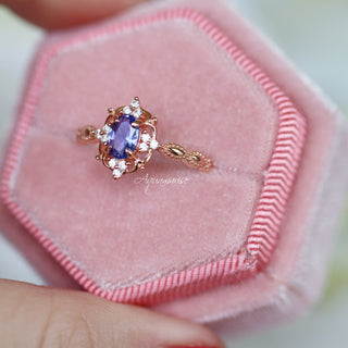 Vintage Tanzanite Ring in 14K Rose Gold Vermeil by Aquamarise featuring an oval violet-blue tanzanite with delicate diamond accents on an intricately detailed rose gold vermeil band.