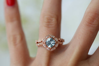 Vintage Cushion Cut Aquamarine Ring in 14k Rose Gold Vermeil by Aquamarise, featuring a detailed rose gold band and a luminous cushion aquamarine center stone on a hand.