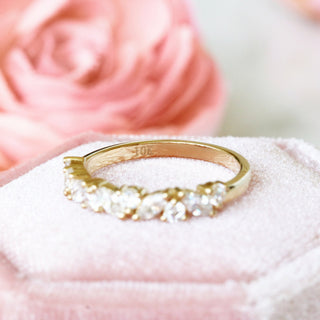 Willow Vintage Marquise Wedding Band in Solid 14K Yellow Gold by Aquamarise Gold featuring alternating marquise and round gemstones in a delicate leaf-inspired design on soft pink fabric.