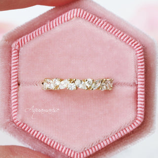 Willow Vintage Marquise Wedding Band in Solid 14K Yellow Gold by Aquamarise Gold featuring marquise and round stones in a delicate leaf-inspired design on a pink velvet ring box.