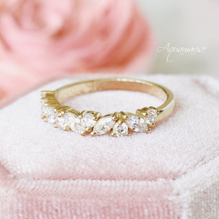 Willow Vintage Marquise Wedding Band in Solid 14K Yellow Gold by Aquamarise Gold featuring marquise and round gemstones arranged in a delicate leaf-inspired design on soft pink velvet.