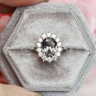 Diana Simulated Gray Diamond Ring in Sterling Silver by Aquamarise, featuring an oval gray simulated diamond surrounded by a halo of white stones on a delicate silver band.