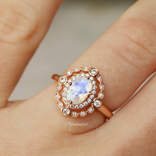 Valentina Rainbow Moonstone Engagement Ring in 14K Solid Rose Gold by Aquamarise Gold featuring an oval rainbow moonstone surrounded by sparkling diamond accents on a vintage-inspired band.