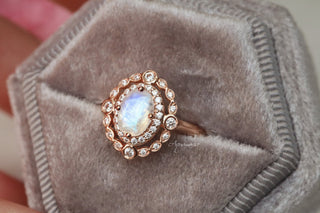Valentina Rainbow Moonstone Engagement Ring in 14K Solid Rose Gold by Aquamarise Gold featuring a glowing oval moonstone surrounded by sparkling diamond accents on a vintage-inspired rose gold band.
