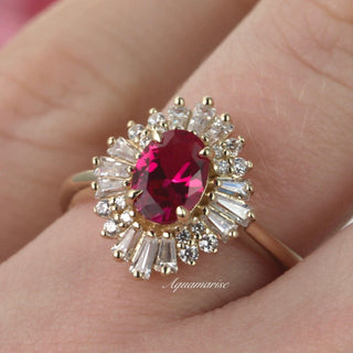 Victoria Vintage Ruby Ring in 14K Yellow Gold Vermeil by Aquamarise featuring an oval ruby center surrounded by radiant baguette and round cut stones on a yellow gold band.