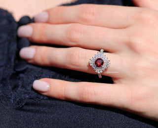 Joelle Vintage Natural Red Garnet Ring in Sterling Silver by Aquamarise featuring a deep red garnet center surrounded by sparkling stones in an intricate vintage-inspired design.