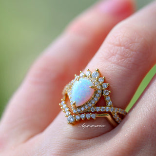 Teardrop White Fire Opal Ring Set in 14K Yellow Gold Vermeil by Aquamarise featuring a glowing pear-shaped opal surrounded by sparkling diamonds in a vintage-inspired fantasy design.