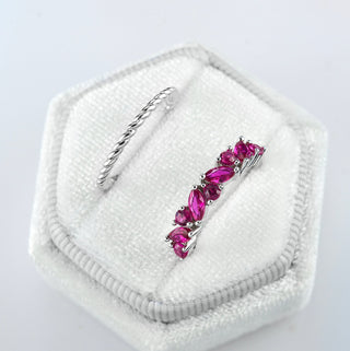 Willow Marquise Cut Ruby Stacking Ring Set in Sterling Silver by Aquamarise featuring a twisted silver band paired with a marquise and round ruby gemstone ring in a bold, elegant design.